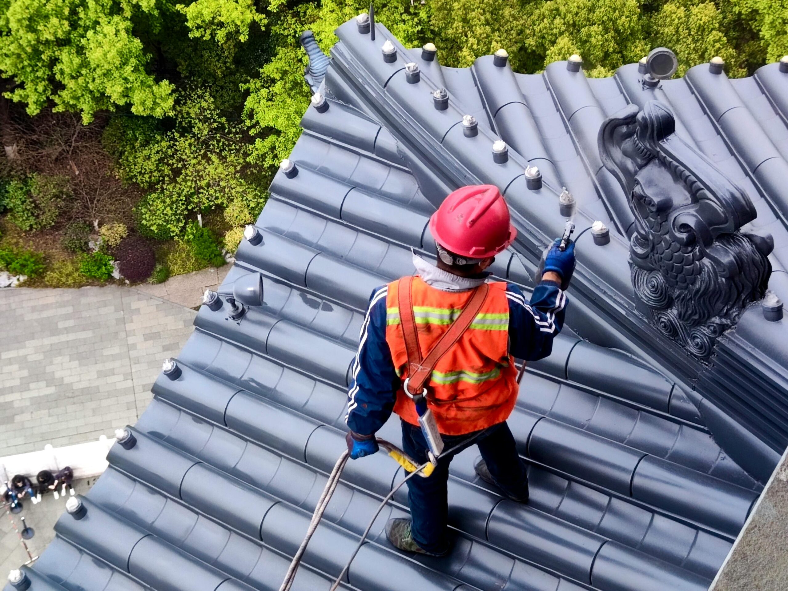 Roofing professional inspecting a roof.